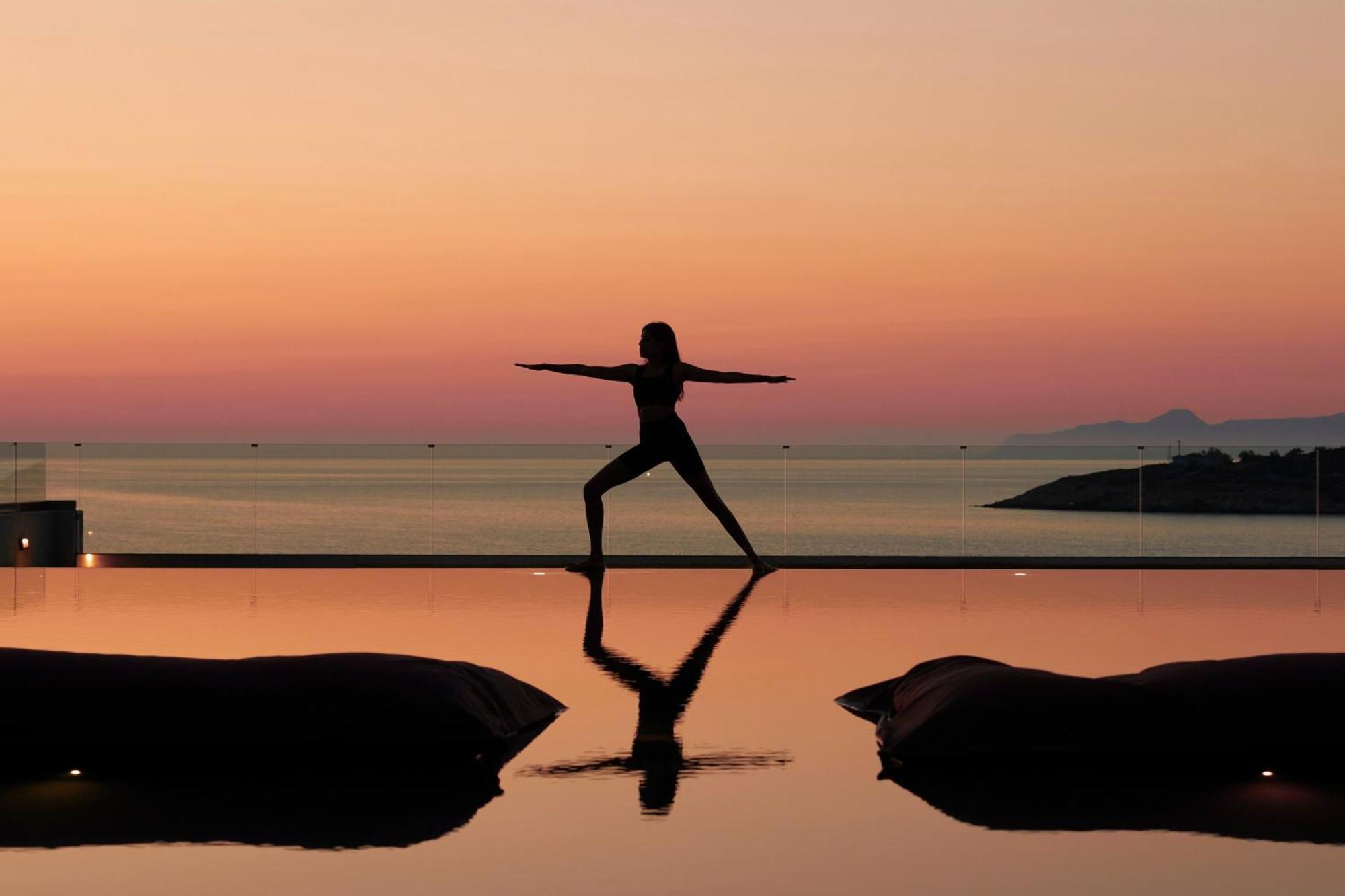 Minos Palace Resort - Adults Only Agios Nikolaos  Exterior photo A woman practicing yoga at sunset